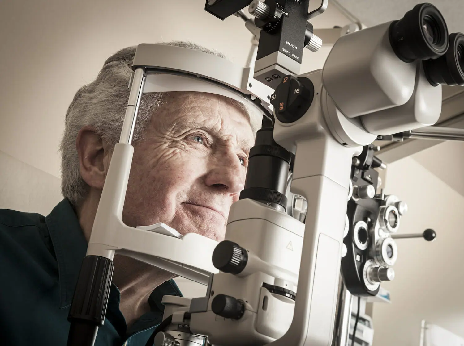 Ophthalmologist giving eye exam to senior patient